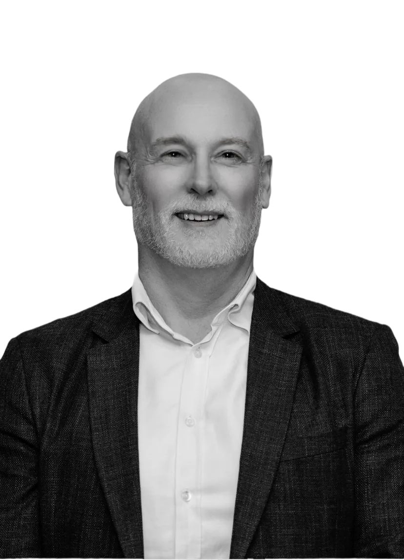 Mark Wist, a smiling bald man with a beard, wearing a blue blazer over a white shirt.