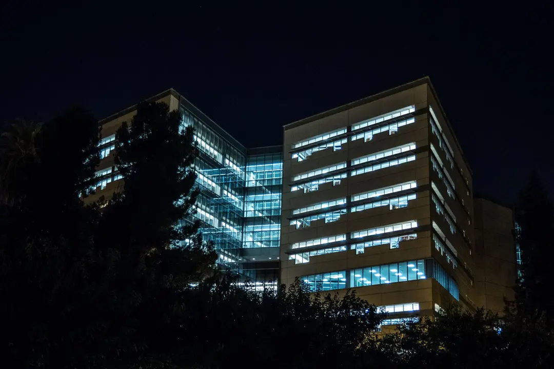 Modern office building at night, lit windows, suggesting cybersecurity and privacy law firm.