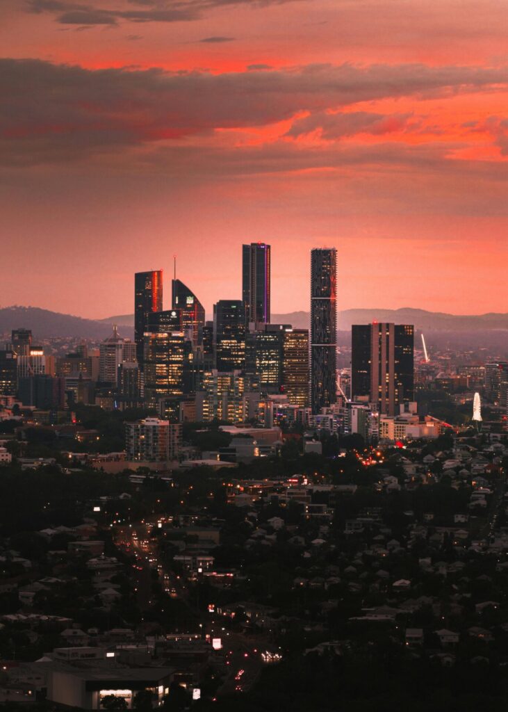 City skyline at sunset with vibrant orange and red sky