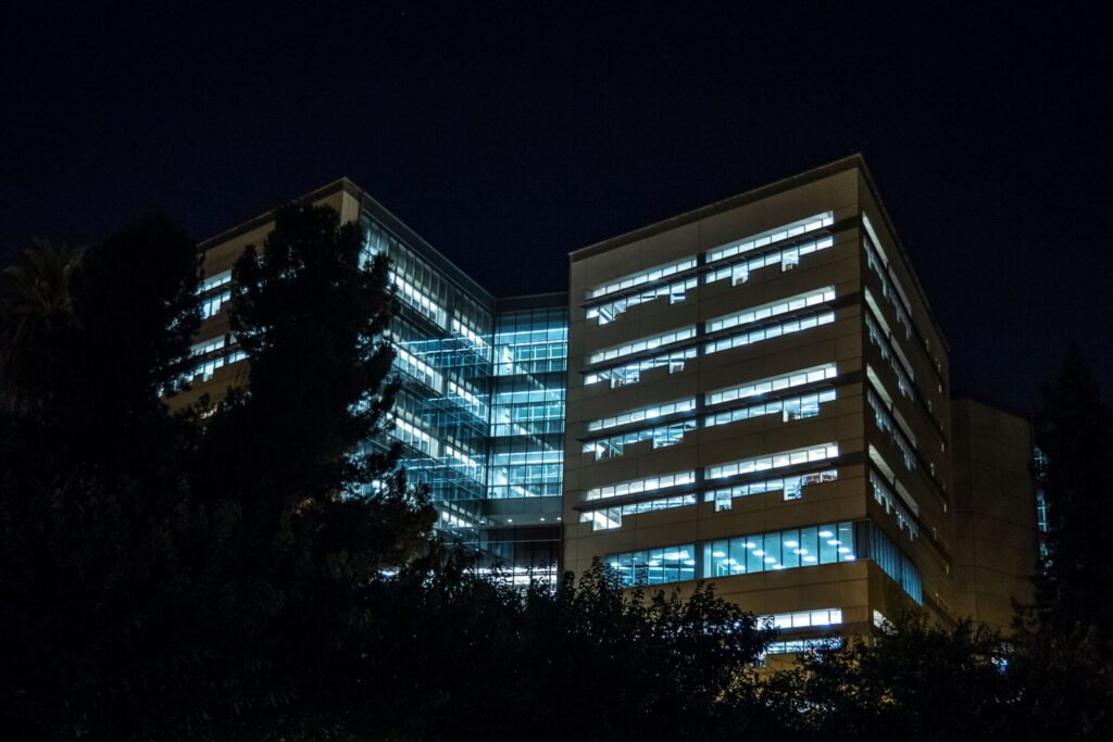 Modern office building at night, lit windows, suggesting cybersecurity and privacy law firm.