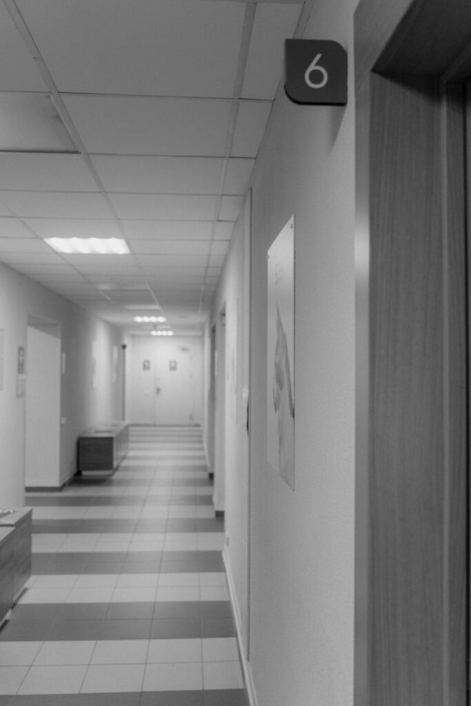 Hallway with numbered doors, possibly in a law office or legal setting.